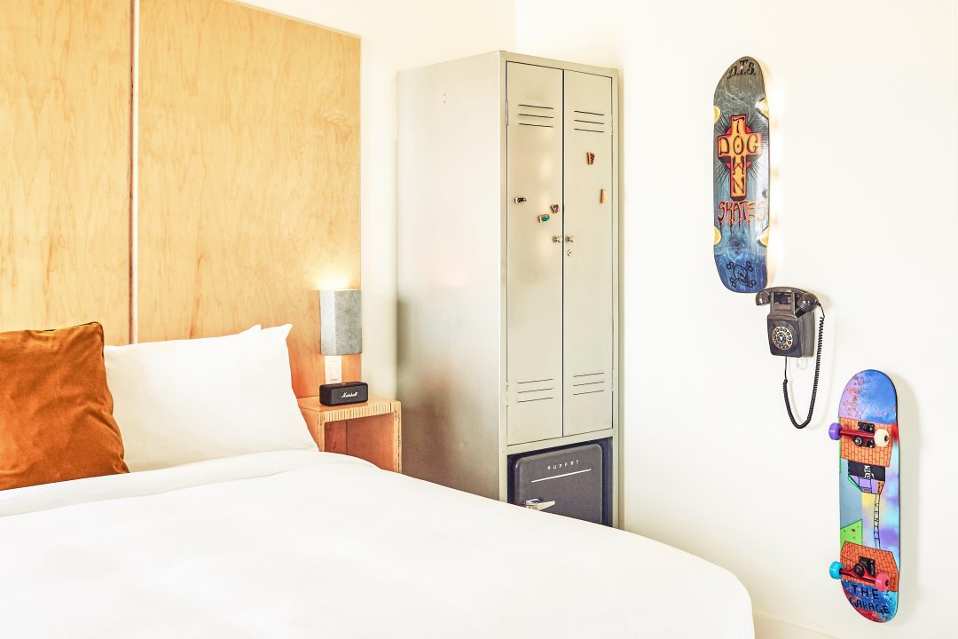 Venice V Hotel Room with close up image of bed and skateboard wall decor
