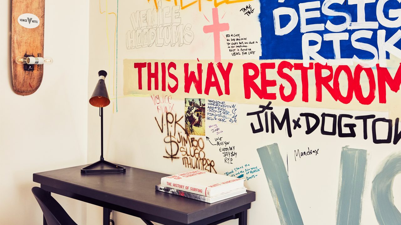 Venice v hotel guest room close up of desk and graffiti art filled wall