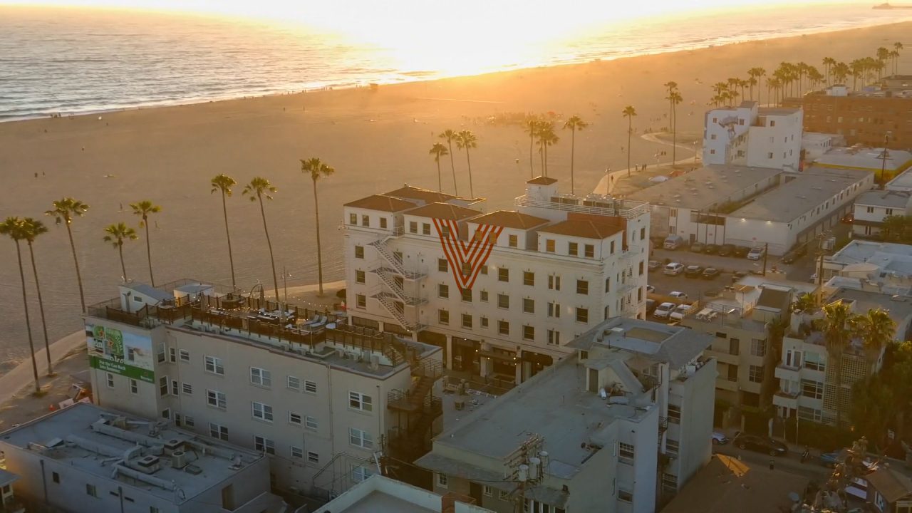 Aerial view of Venice V Hotel with view of pacific ocean at sunset