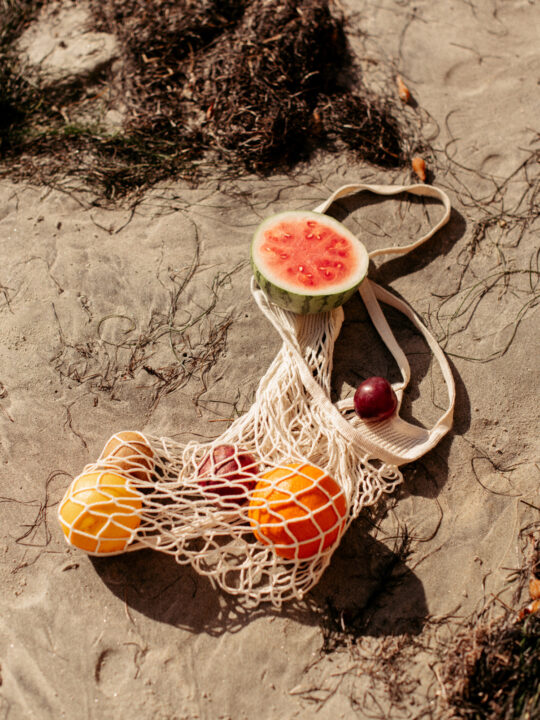 fruits in a eco friendly bag on the beach